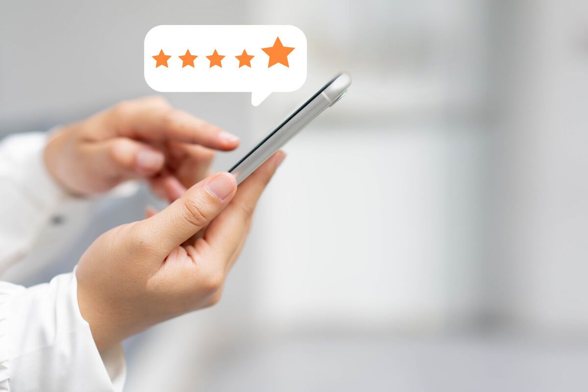 customer-woman-hand-pressing-smartphone-screen-with-gold-five-star-rating-feedback.jpg