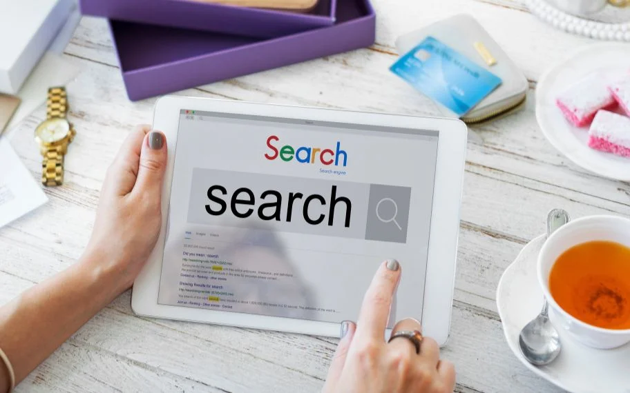 Hands using a tablet to run a search and review the results page.