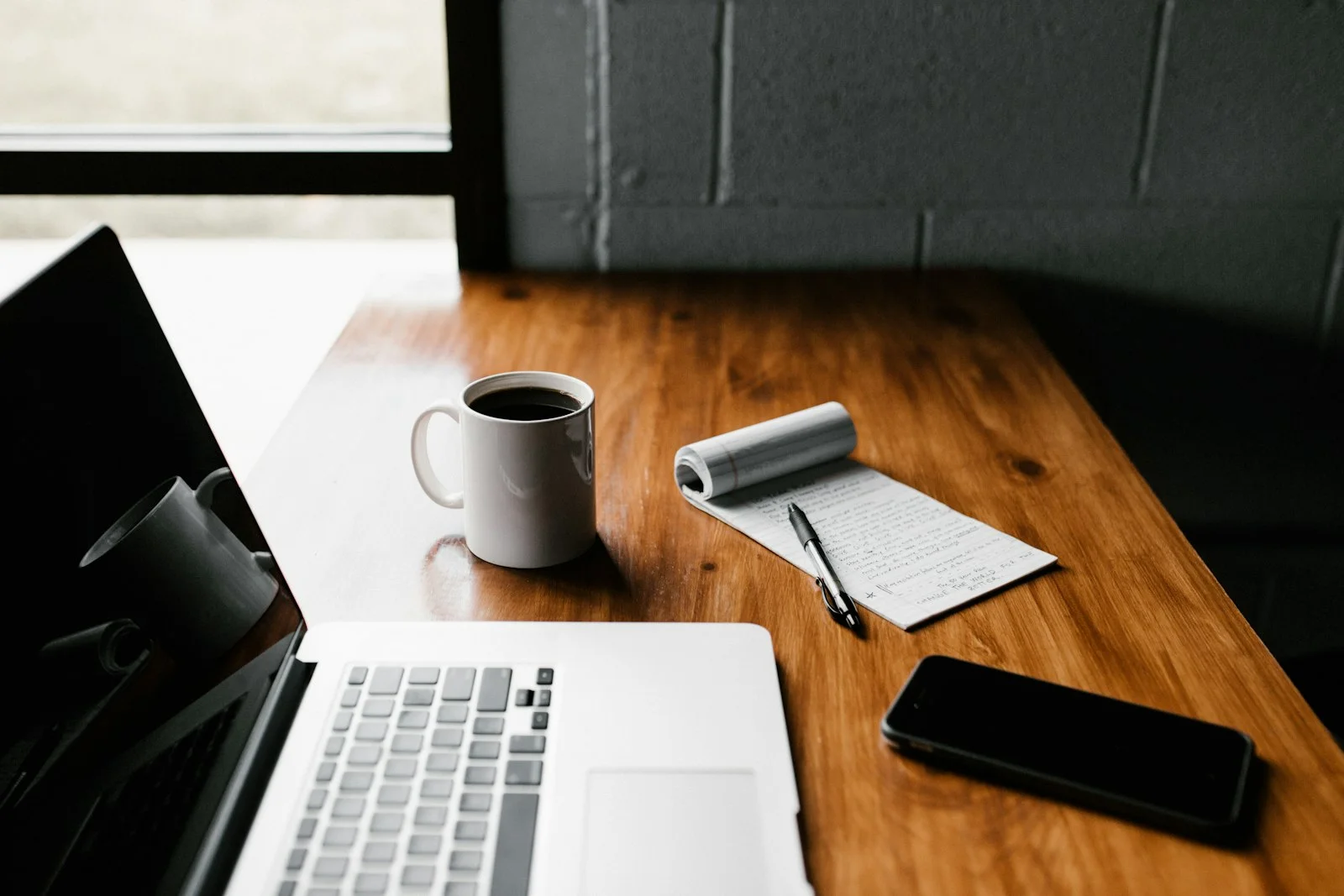 Healthcare marketer planning website and blog content strategy at a laptop