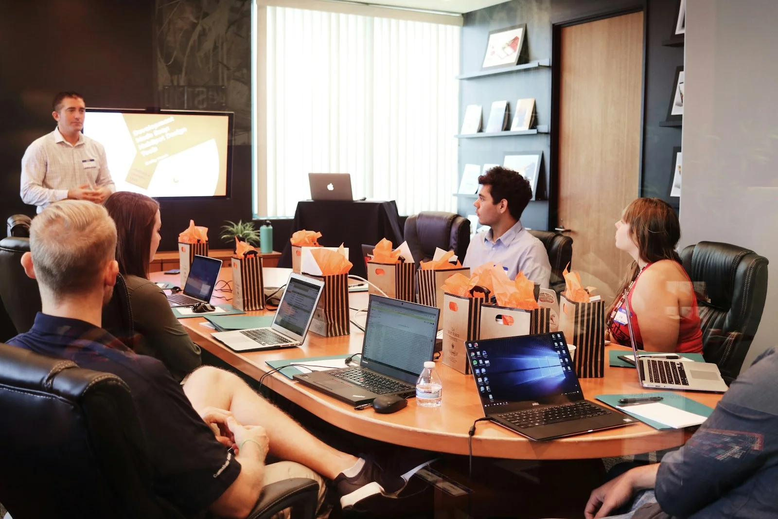 Marketing team reviewing video performance analytics and retention curves on a laptop