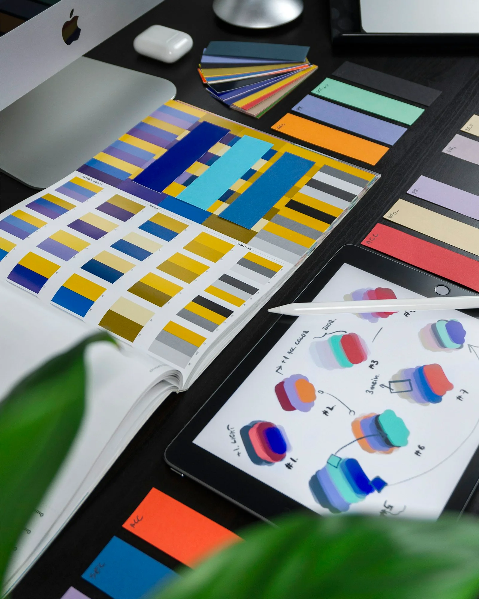 Designer arranging dental brand identity elements, color swatches and typography on a screen